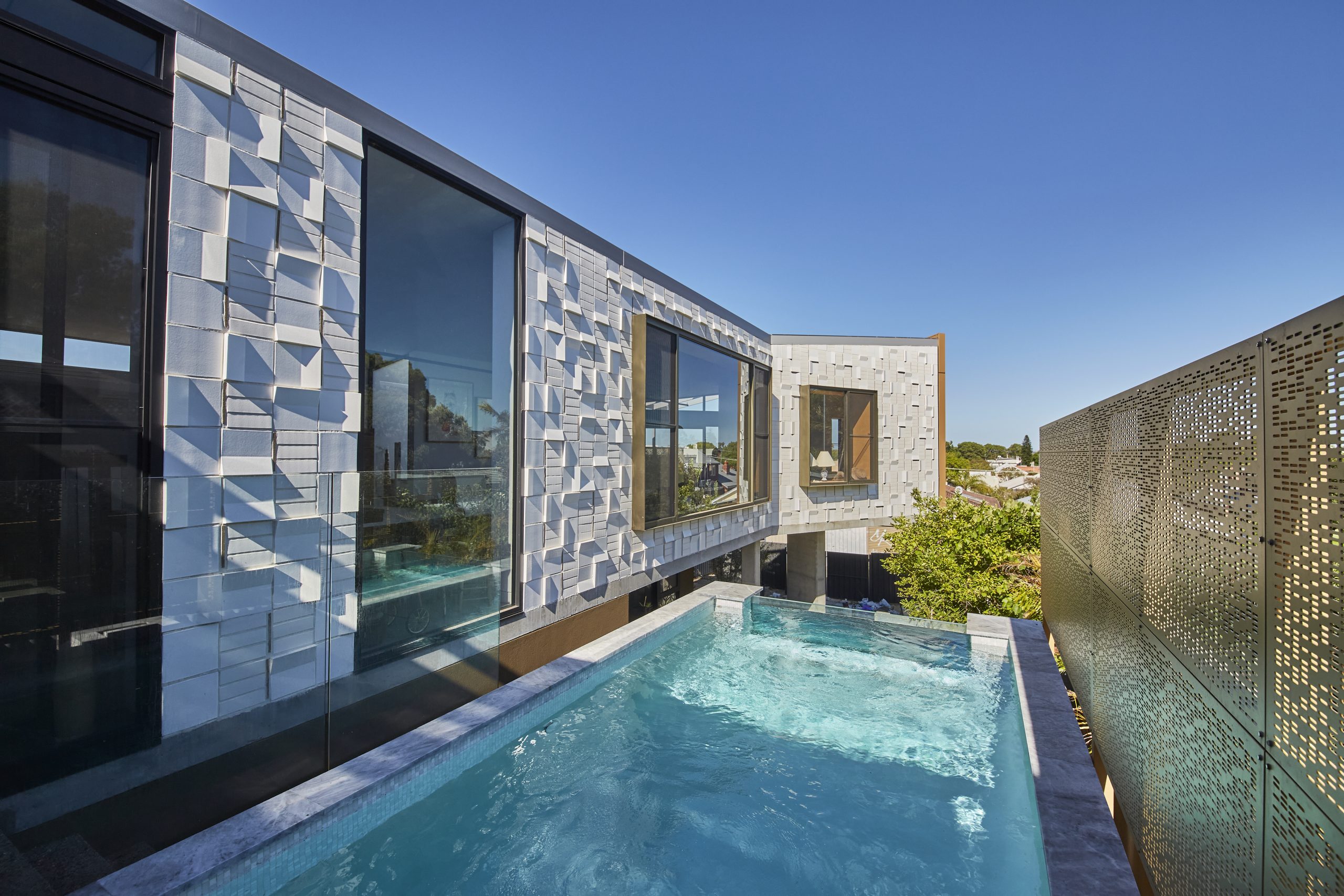 Luxury modern home with swimming pool, outdoor living area and contemporary architectural design